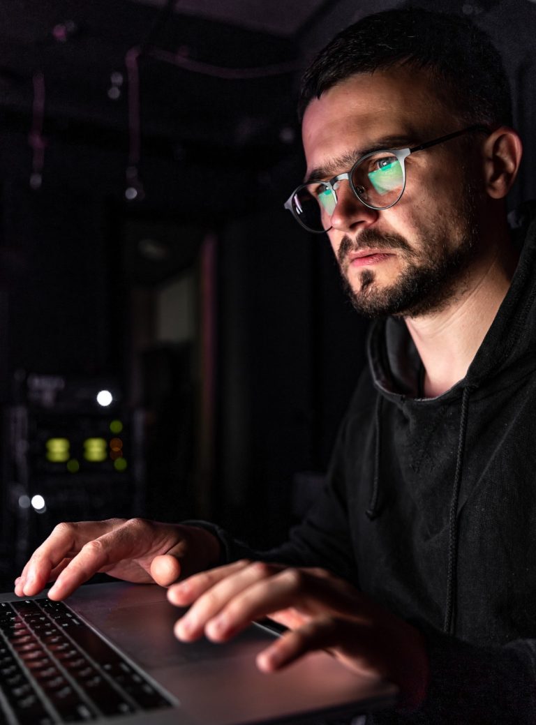 man-with-glasses-works-computer-late-night